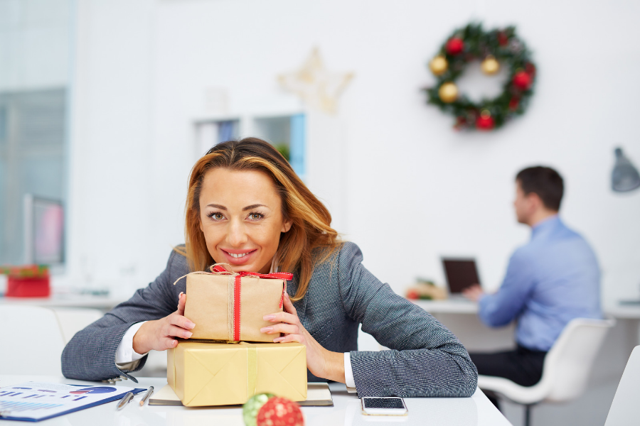 Rising employee satisfaction shows woman happy at work during the holidays